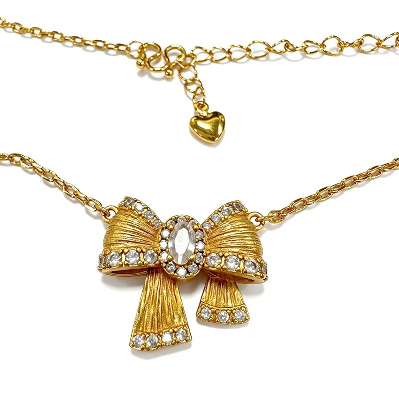 Gold bow necklace packaging with care cloth