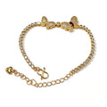 Gold butterfly bracelet with pavé stones and a red marquise stone
