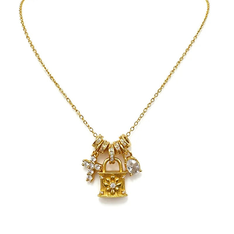 Gold charm necklace with lock, ring and cross pendants