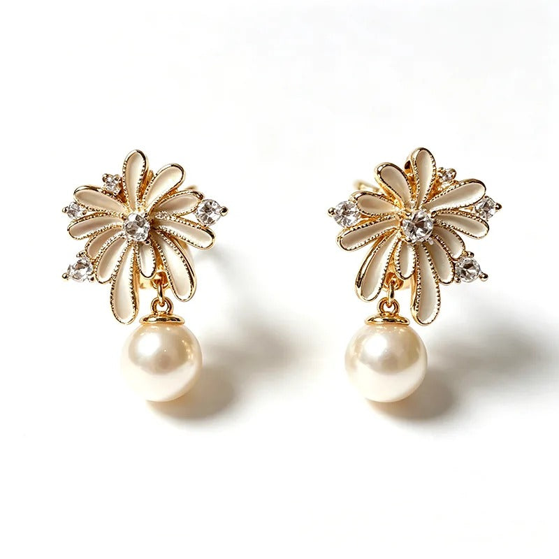 Gold pearl stud earrings with a ray-set burst