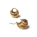 Gold twisted hoop earrings with a sculpted wave surface