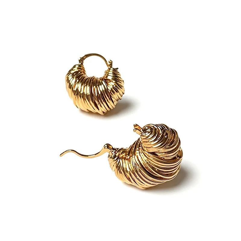 Gold twisted hoop earrings with a sculpted wave surface