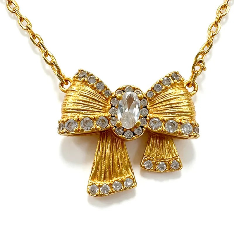 Coquette bow necklace worn at the collarbone